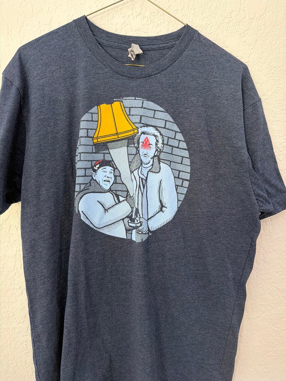 Next Level t-shirt a combination of Christmas story and Home Alone.